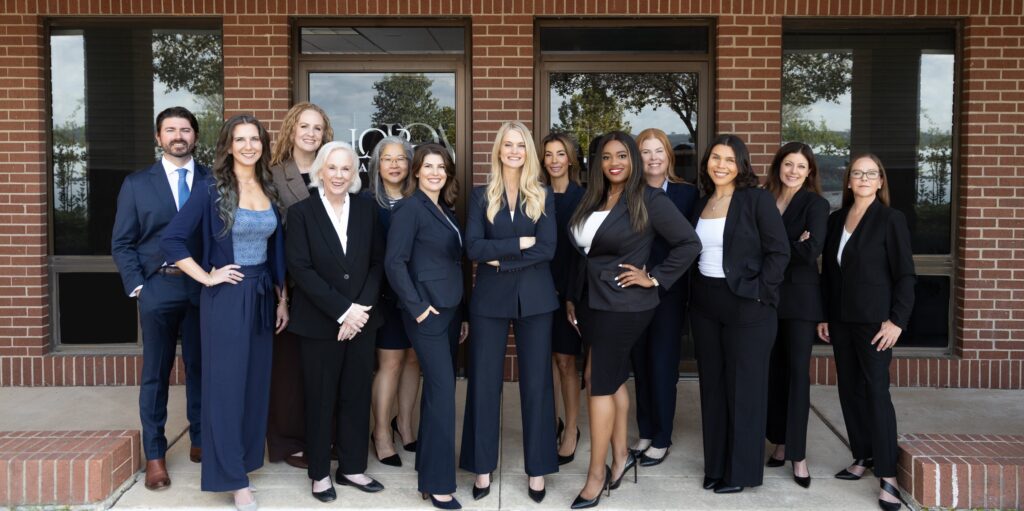 The LOAR PLLC team standing outside the entrance to the firm's office